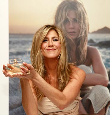 Jennifer Aniston poses with her fragrance 'Jennifer Aniston' during its launch at Harrods in London.