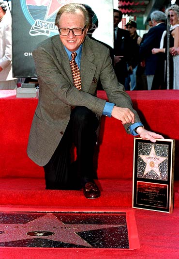 Larry King poses with his plaque after his star on the Hollywood Walk of Fame in 1997