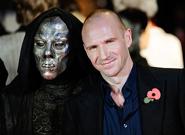 Ralph Fiennes poses with the mask of evil