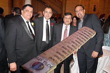 Rajeev Bambari, Atul Kumria, Prabhu Dayal and Kapil Kumria pose with the signed cricket bat.