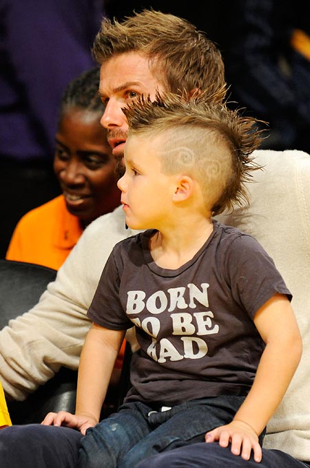Cruz sits in father David Beckham's lap
