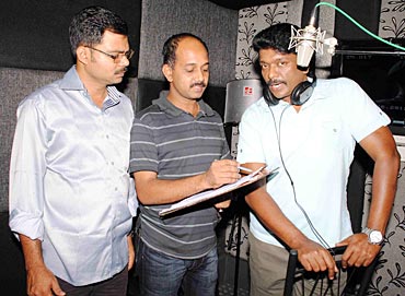 Parthiban (right) at a dubbing session