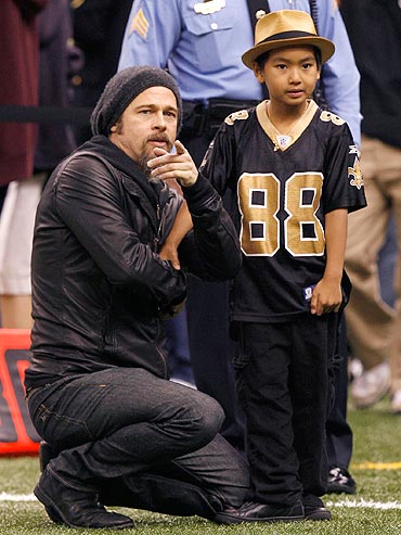 Brad Pitt and Maddox at an NFL's NFC Divisional playoff football game