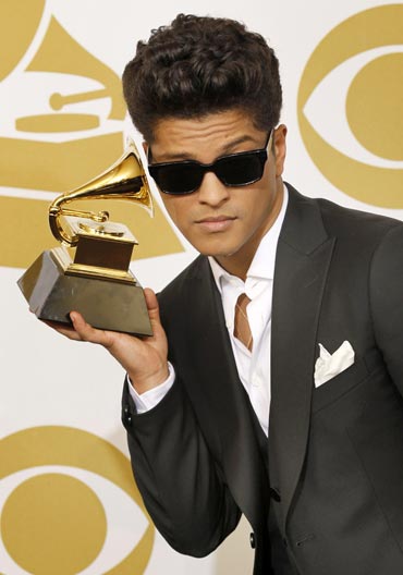 Bruno Mars poses backstage with his award for Best Male Pop Vocal Performance for Just The Way You Are