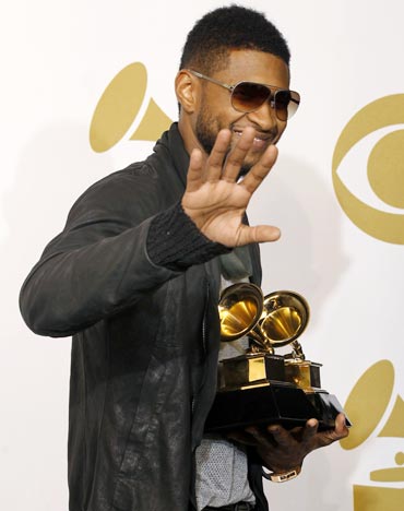 Usher poses with his awards for Best Contemporary R and B Album for Raymond V Raymond and Best Male R and B Vocal Performance for There Goes My Baby