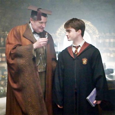 Professor Slughorn holds Felix Felicis for Harry to see