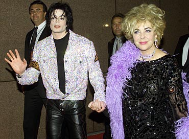 Singer Michael Jackson and actress Elizabeth Taylor arrive at a concert