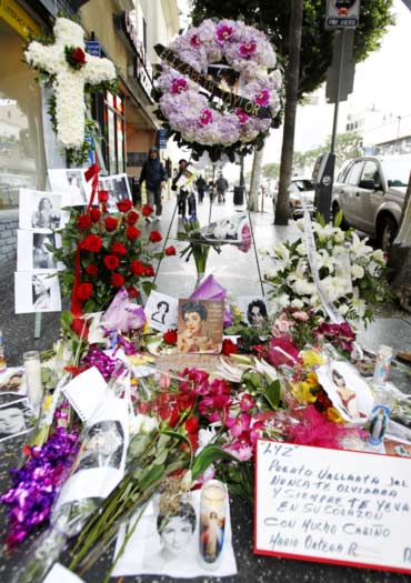 Flowers, photographs and notes from fans adorn the Hollywood Walk of Fame star of Elizabeth Taylor in Hollywood, California