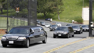 Limousines carrying Liz Taylor's relatives leave after her funeral at Forest Lawn Memorial Park in California