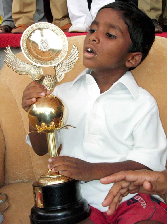 Budhia Singh, a four-year-old child, holds his trophy after a marathon in the eastern Indian city of Bhubaneswar