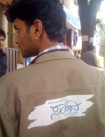 A Darshan fan wears the uniform given to him during the audio launch