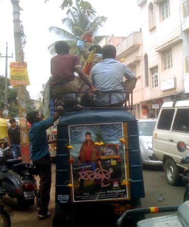 Fans take out a procession in an auto as part of the release celebration