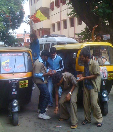 Autorickshaw drivers celebrate the release of the film