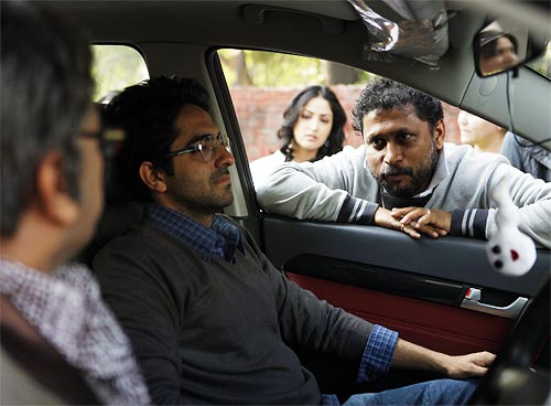 Shoojit Sircar explains a scene to Ayushmann Khurrana and Annu Kapoor as Yami Gautam (not part of that scene) peers in the background