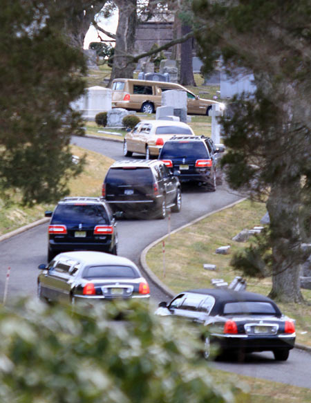 The hearse carrying the body of Whitney Houston arrives for her burial service at the Fairview Cemetery