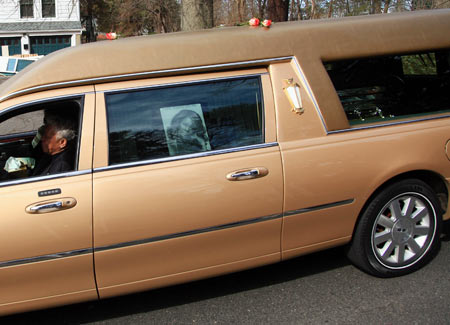 The hearse carrying the body of singer Whitney Houston arrives for her burial service at the Fairview Cemetery