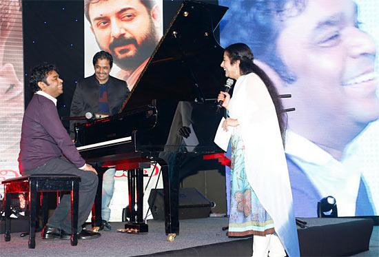 Rahman sits at the piano