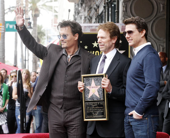 Johnny Depp and Tom Cruise pose with film and television producer Jerry Bruckheimer