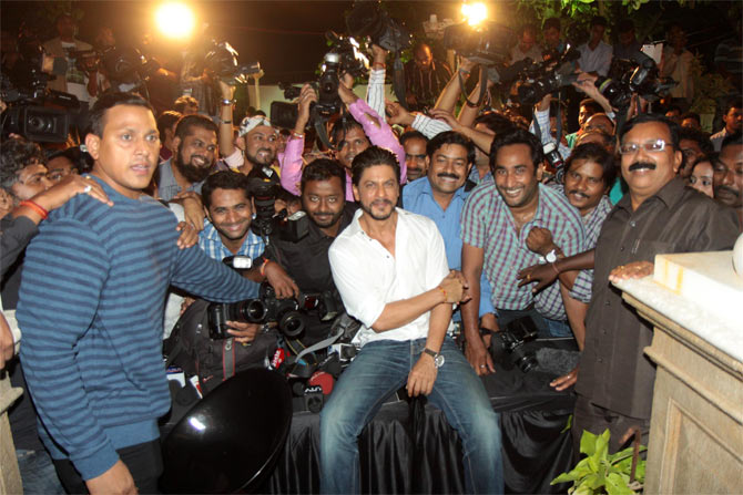 Shah Rukh Khan poses with the media