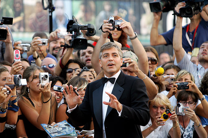 George Clooney signs autographs as he arrives at the Cinema Palace in Venice in 2005.