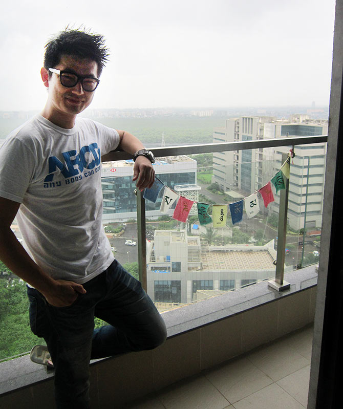 Meiyang Chang poses in his balcony