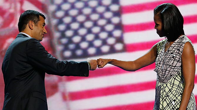U.S. first lady Michelle Obama "fist-bumps" actor and Obama administration official Kal Penn
