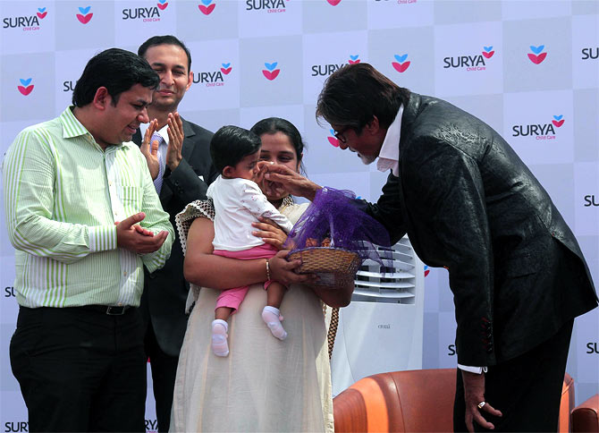 Amitabh Bachchan plays with a kid at Surya Hospital