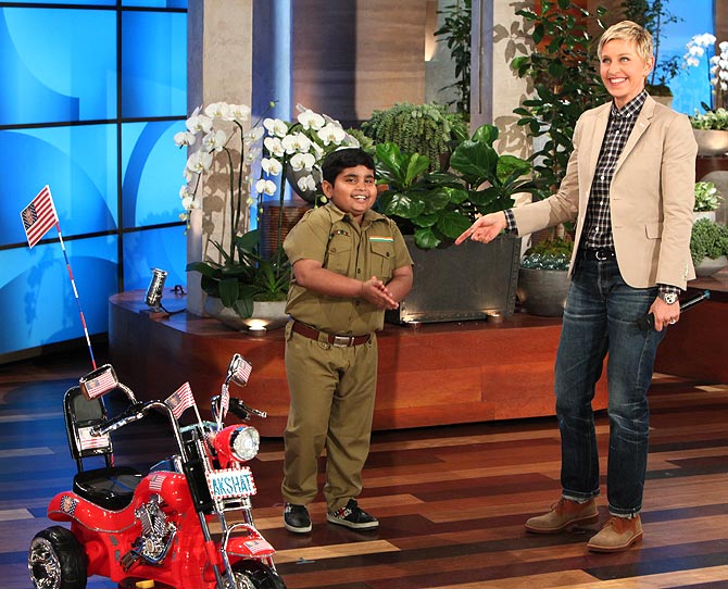 Akshat with Ellen DeGeneres and his new bike