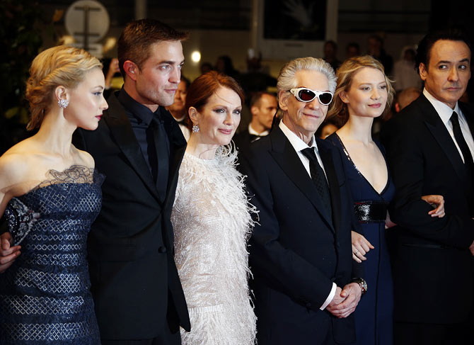 Julianne Moore (in white) with cast members (left to right): Sarah Gadon, Robert Pattinson, director David Cronenberg, actress Mia Wasikowska and actor John Cusack at the film's premiere