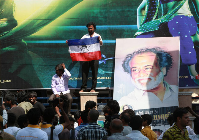 Fans display posters and flags of Rajinikanth