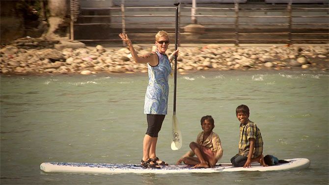 Michelle Baldwin, with children, on river Ganga