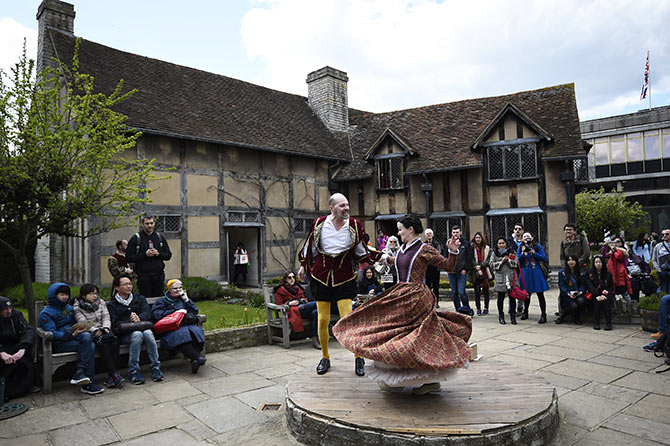 Tourists watch actors perform at the house where William Shakespeare was born during celebrations to mark the 400th anniversary of the playwright's death in Stratford-Upon-Avon.