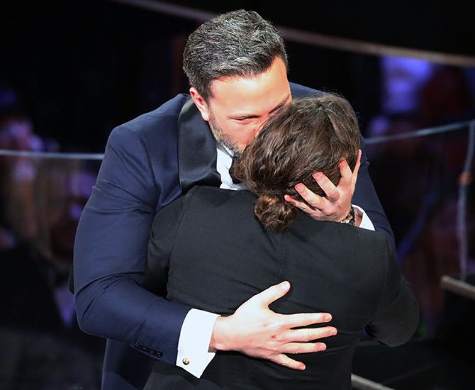 Ben Affleck kisses his younger brother after Casey Affleck  won the Best Actor Oscar.