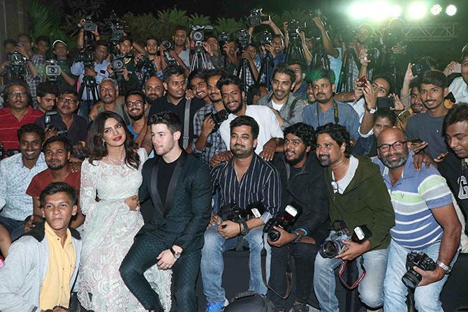 Priyanka and Nick pose with the photographers at their wedding