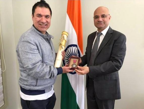 Sarfaraz Khan receives the Padma Shri from Dinesh Bhatia, India's consul general in Toronto, right.