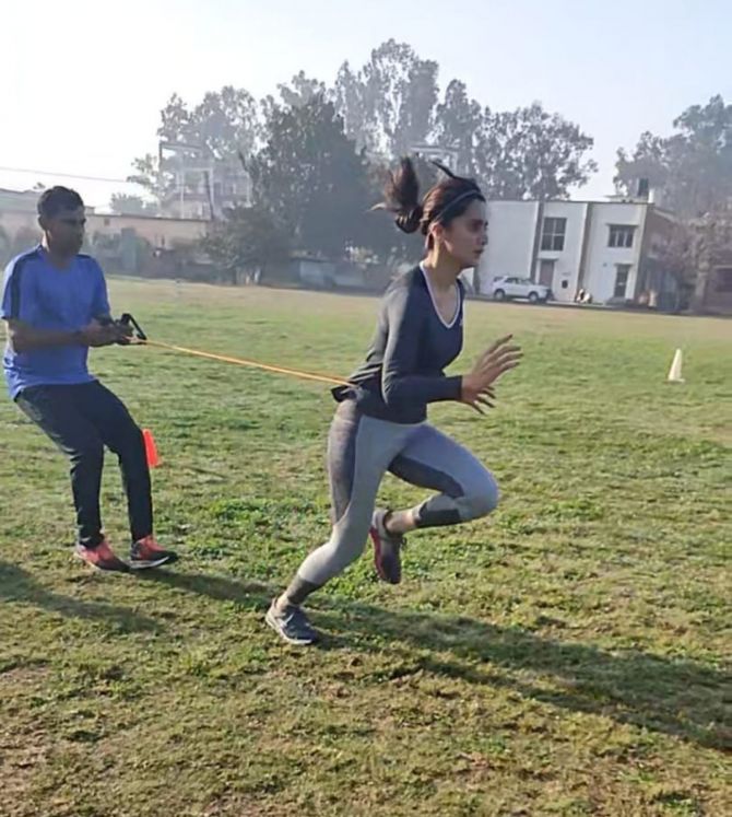 Melwyn Crasto assists Tapsee Pannu during resistance training