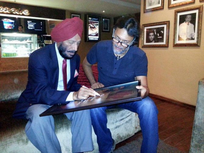 Milkha Singh signs a poster of the film