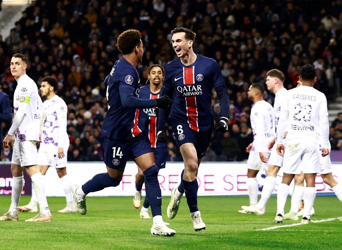 Paris St Germain's Fabian Ruiz celebrates with Desire Doue after scoring the only goal of the match against Toulouse.