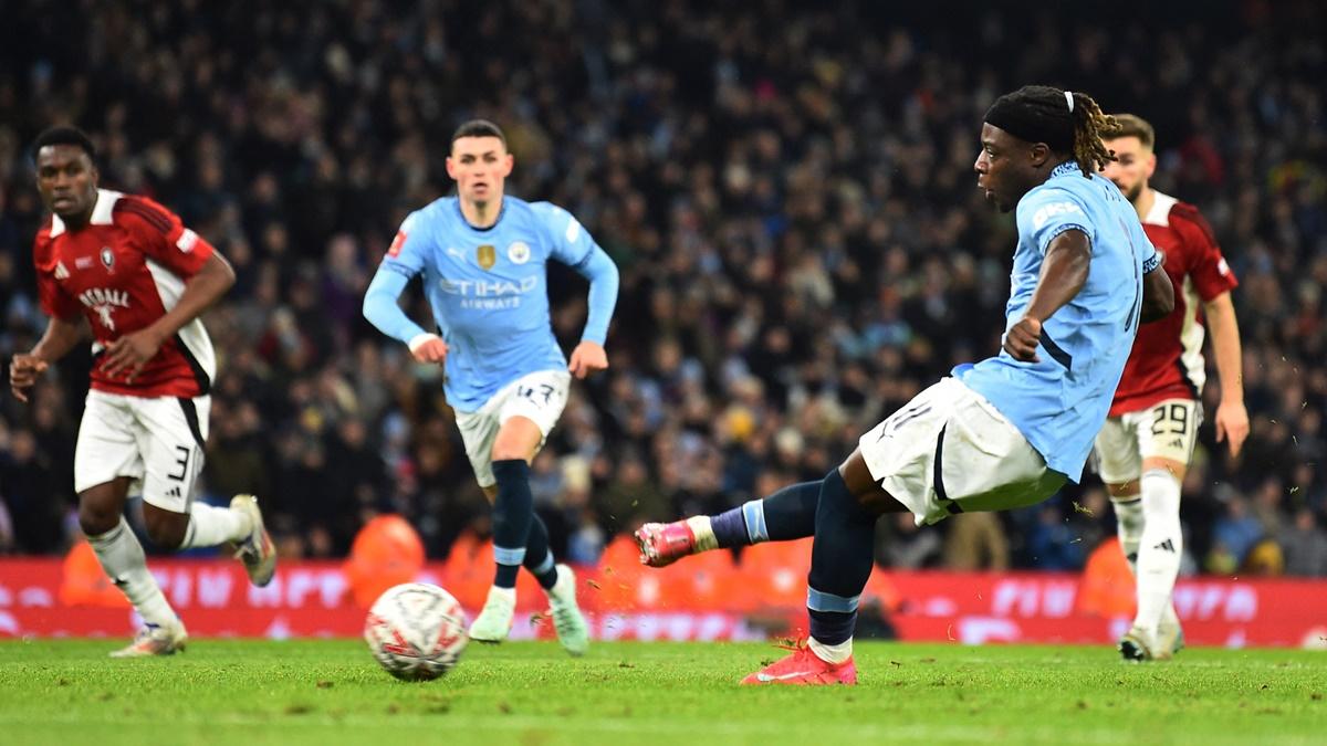 Jeremy Doku scores Manchester City's sixth goal from the penalty spot against Salford City at Etihad Stadium, Manchester.