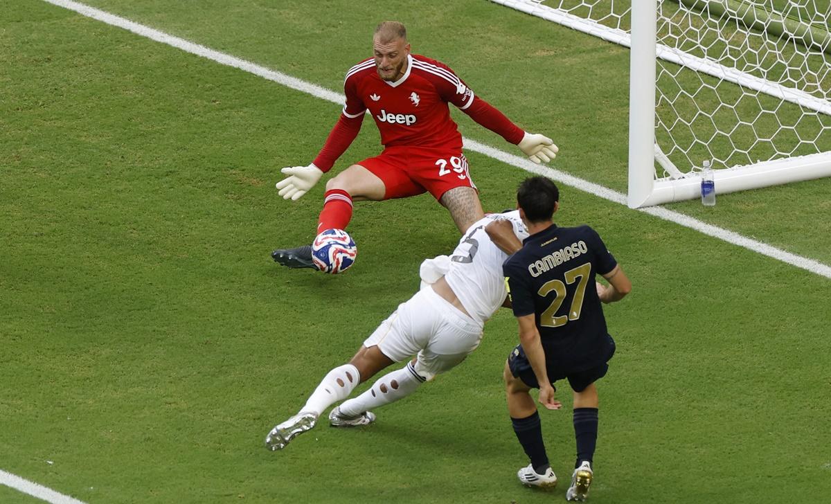 Juventus goalkeeper Michele Di Gregorio saves a shot from Real Madrid's Jude Bellingham.