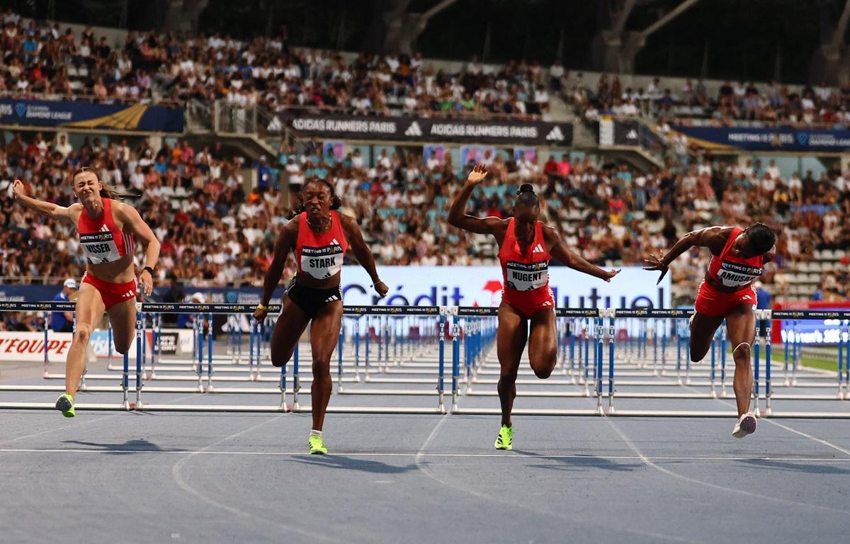 Grace Stark of the United States crosses the line to win the women's 100m hurdles ahead of second placed Nigeria's Tobi Amusan and third placed Jamaica's Ackera Nugent.