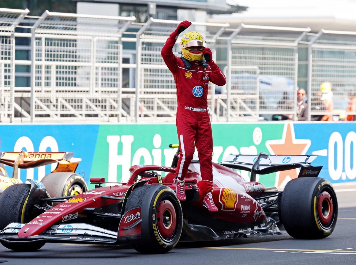 Lewis Hamilton celebrates atop his Ferrari after winning the sprint.