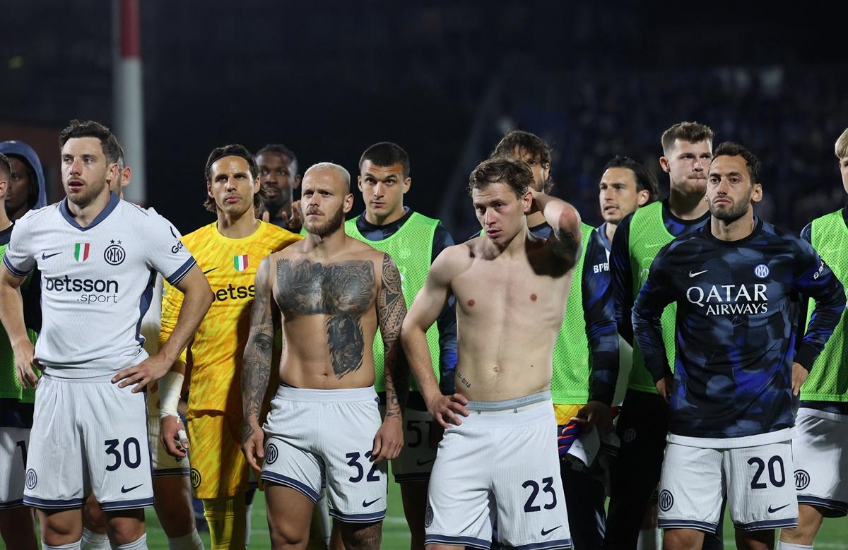 Inter Milan's Carlos Augusto, Federico Dimarco, Nicolo Barella and Hakan Calhanoglu react after the match.