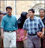Patani (head covered) being led to the court. Photo: Arun Patil