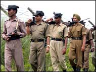 Border Security Force troopers along the fenced India-Bangladesh border in Assam