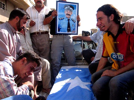 Relatives cry during a funeral of Brig.Sabah Qara Alton, a Turkman official who was shot dead in  Kirkuk City June 3. (AP Photo)