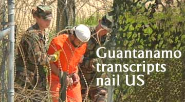 A detainee is escorted for interrogation by US military guards at Camp X-Ray,  Guantanamo Bay US Naval Base, Cuba (AP File photo)