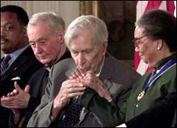 Galbraith  kisses the hand of Marian Wright Edelman, president, Children's Defense Fund, after receiving the Presidential Medal of Freedom, the highest American civilian award, in the East Room of the White House August 9, 2000. Photograph: Tim Sloan/AFP/Getty Images