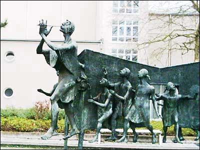 A depiction of the Pied Piper leading the children away