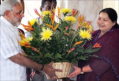 Gujarat Chief Minister Narendra Modi presents a bouquet to AIADMK Supremo J Jayalalithaa at her residence in Chennai